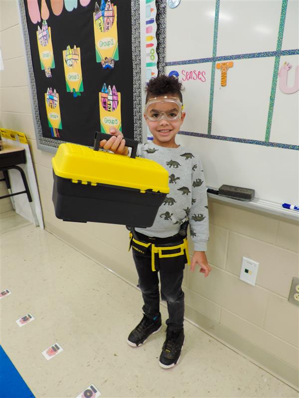 student smiling with toolbox